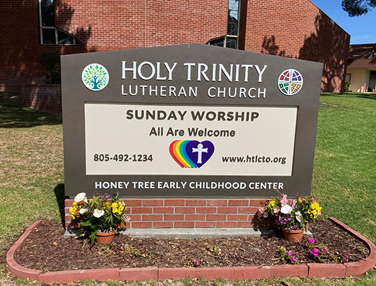 Holy Trinity Lutheran Chuch Sign Featuring Rainbow Logo