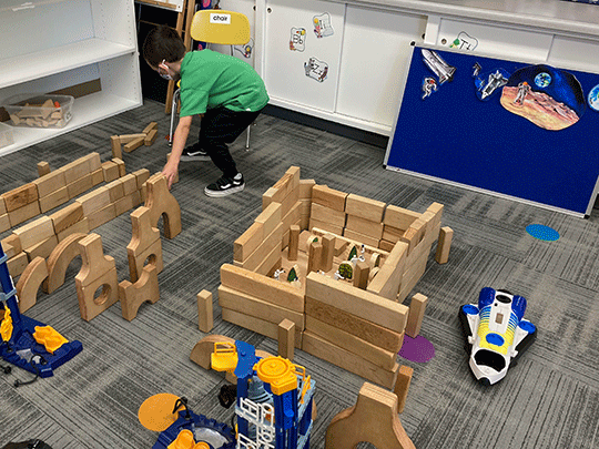 Youg Boy Building A Block Castle