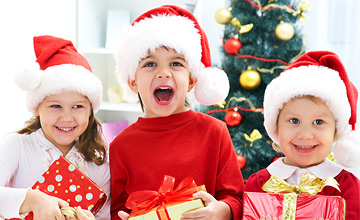 Three children with Santa hats