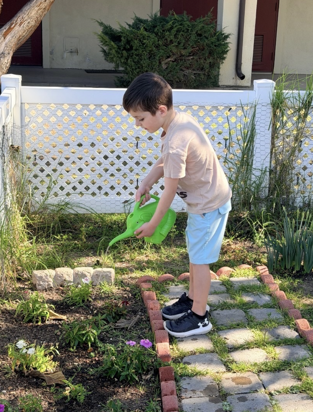 Boy Watering Garden