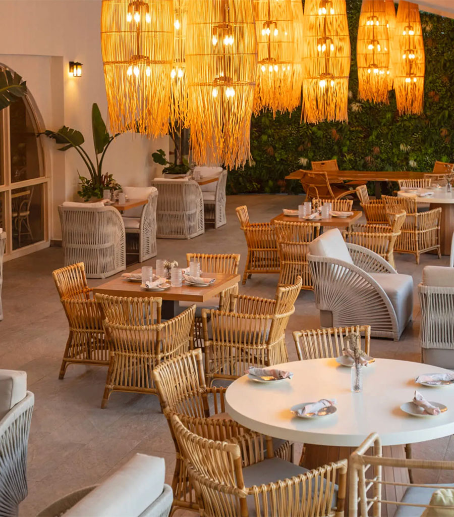 An elaborate chandelier hangs over tables in the Wyndham Hotel Las Palmas restaurant.