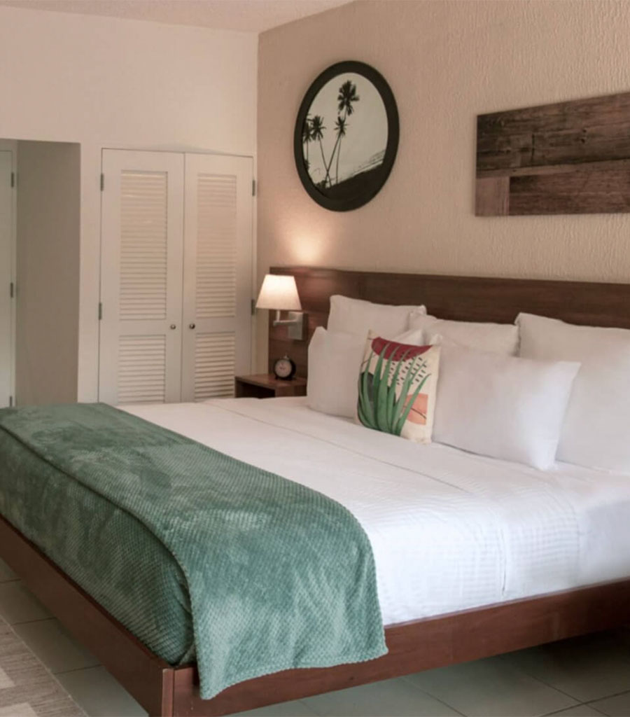 Sage accents highlight the Wyndham Hotel Las Palmas king guest room.