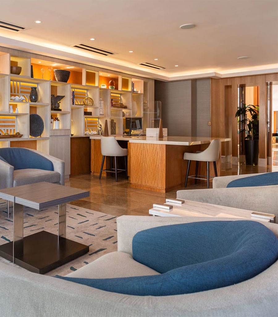 JW Marriott Panama Lobby featuring gray chairs with blue back rests with matching colors echoed in the carpet.