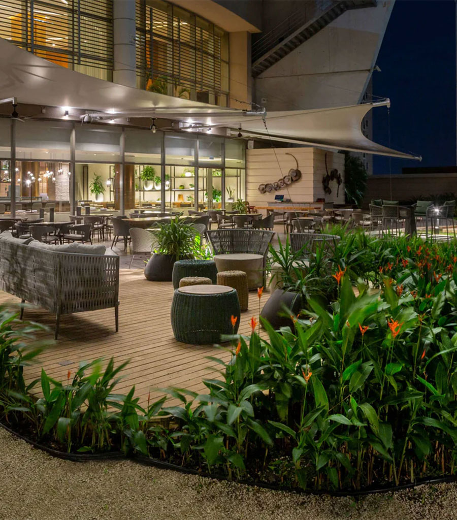 JW Marriott Panama Patio featuring outdoor dining and outdoor seating areas surrounded by tropcial plants.