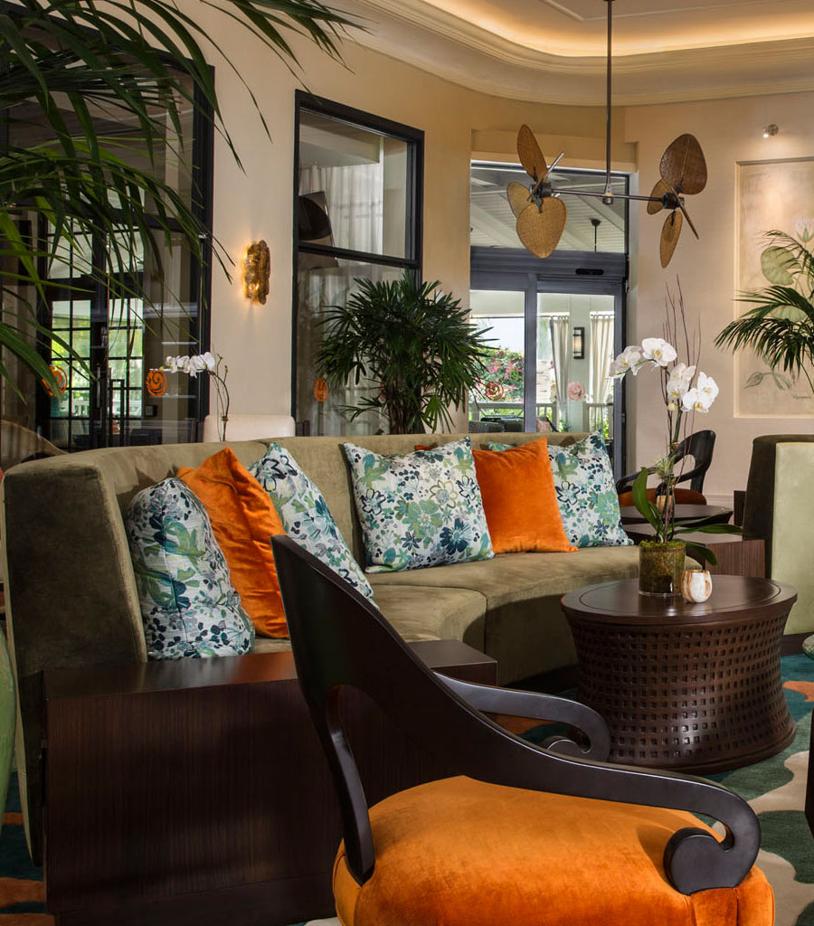 The Palms Hotel Miami Lobby featuring a semi-circular couch and palm bladed ceiling fans.